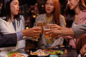 Happy Group of people Asian friends Drinking beer outdoors at the brewery for the New Year festival night time
people