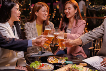 Happy Group of people Asian friends Drinking beer outdoors at the brewery for the New Year festival night time
people