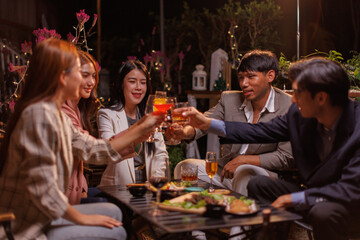 Group of people Throw a party Celebrate whiskey at a friendly party in a restaurant. Night.
