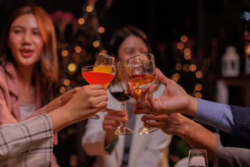 Group of people Throw a party Celebrate whiskey at a friendly party in a restaurant. Night.
