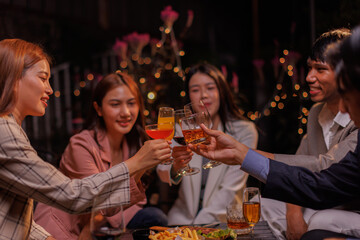 Group of people Throw a party Celebrate whiskey at a friendly party in a restaurant. Night.
