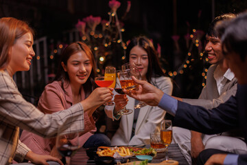 Group of people Throw a party Celebrate whiskey at a friendly party in a restaurant. Night.
