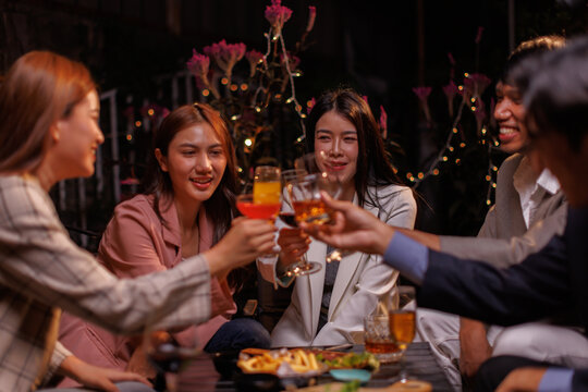 Group of people Throw a party Celebrate whiskey at a friendly party in a restaurant. Night.
