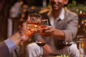 Happy Group of people clinking glasses of whiskey in celebration, Holiday, Festival celebration.
