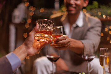 Happy Group of people clinking glasses of whiskey in celebration, Holiday, Festival celebration.
