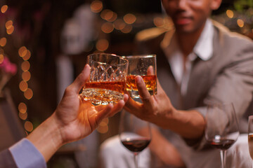 Happy Group of people clinking glasses of whiskey in celebration, Holiday, Festival celebration.
