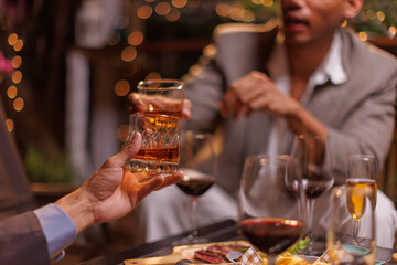 Happy Group of people clinking glasses of whiskey in celebration, Holiday, Festival celebration.
