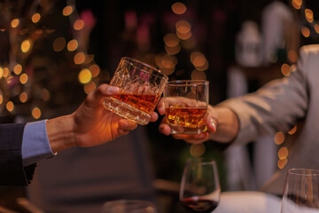Happy Group of people clinking glasses of whiskey in celebration, Holiday, Festival celebration.
