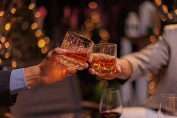 Happy Group of people clinking glasses of whiskey in celebration, Holiday, Festival celebration.
