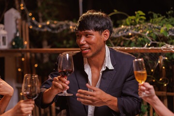 Glasses of Happy friends rose wine seen during a friendly party of a celebration.
