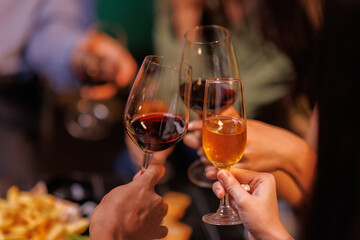 Glasses of Happy friends rose wine seen during a friendly party of a celebration.
