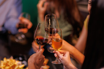 Glasses of Happy friends rose wine seen during a friendly party of a celebration.
