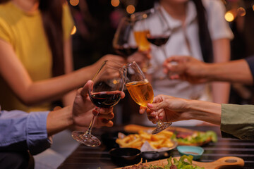 Glasses of Happy friends rose wine seen during a friendly party of a celebration.
