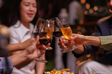 Group of people toasting with champagne glasses at a celebration. Hands holding champagne, clinking glasses. Festive atmosphere, joyful celebration, champagne toast. People toasting with champagne.
