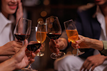 Group of people toasting with champagne glasses at a celebration. Hands holding champagne, clinking glasses. Festive atmosphere, joyful celebration, champagne toast. People toasting with champagne.
