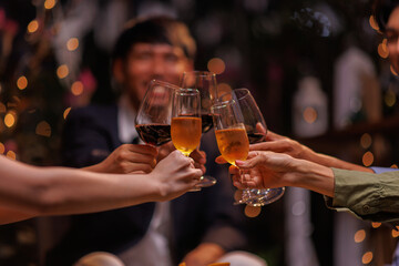 Group of people toasting with champagne glasses at a celebration. Hands holding champagne, clinking glasses. Festive atmosphere, joyful celebration, champagne toast. People toasting with champagne.
