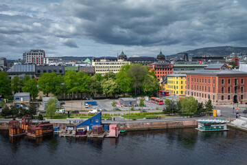 The skyline of Oslo rises above the serene blue fjord.