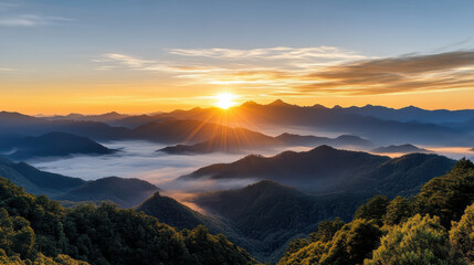 Golden sunrise over mountain range with soft clouds and vibrant colors