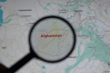 A magnifying glass highlights the country of Afghanistan on a world map, representing focus on its national boundaries, geopolitical relevance, and role in international geography and travel.