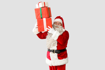 Santa Claus with Christmas gifts on white background