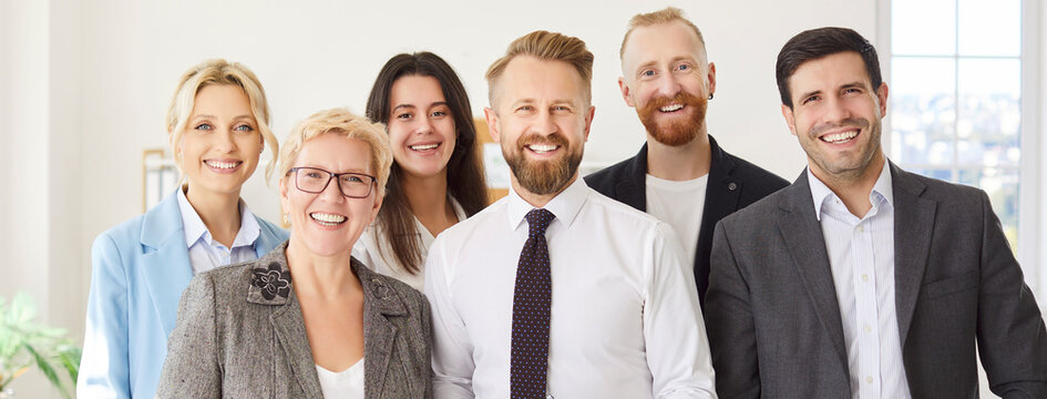 Group portrait showcasing happy and smiling coworkers in an office, emphasizing teamwork, professional success, and team collaboration between people within a thriving business community.