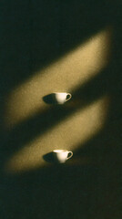 Minimalist still life with coffee cups and dramatic light and shadow