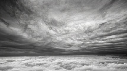 a serene grayscale expanse unfolds, showcasing layered formations of clouds above a sea of fluffy vapor creating an ethereal atmosphere