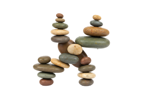 Various river stones are stacked vertically forming the letter H symbolizing balance, stability, and initials.