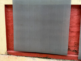 A black and white striped piece of cloth is hanging on a wall