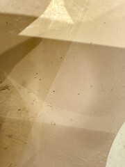 A blurry image of a wall with a few spots and a shadow