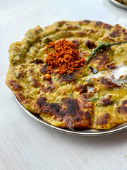 A plate of food with a green and yellow dish on top