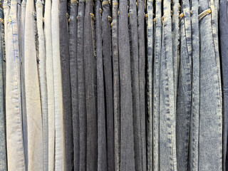 A row of jeans in various shades of blue