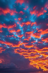 Obraz premium Fiery clouds of red and yellow paint the twilight sky, evening, vibrant sky, evening atmosphere