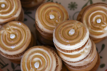Delicious close up of gourmet homemade cupcakes with toasted meringue frosting. This sweet baked dessert with beautiful swirl topping looks absolutely irresistible