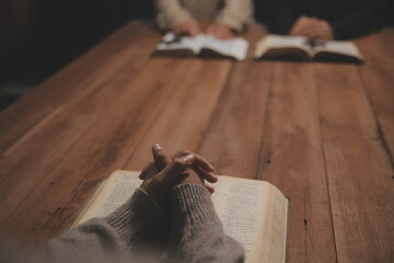 Christian group are praying to god with the bible and sharing the gospel. Concept of faith for god.
