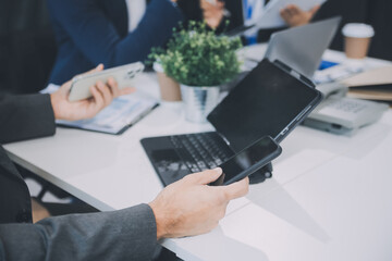 Group of colleagues engaging in a discussion during a business meeting in a conference room. Happy business people, men and women, collaborating and working towards their shared goals.