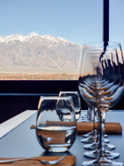 Wine glasses standing by the window overlooking the vineyard and Andes