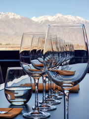 Wine glasses standing by the window overlooking the vineyard and Andes