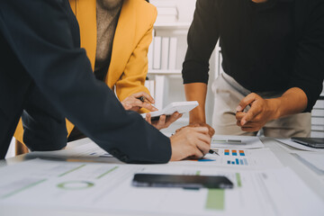 Financial analysts analyze business financial reports on a digital tablet planning investment project during a discussion at a meeting of corporate showing the results of their successful teamwork.