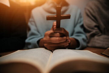 Christian group are praying to god with the bible and sharing the gospel. Concept of faith for god.