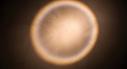 Close-up of a glowing, circular light source with a soft halo effect against a dark background