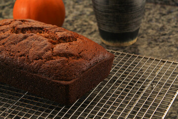Fresh Homemade Pumpkin Bread Cooling on Wire Rack with Warm Fall Colors