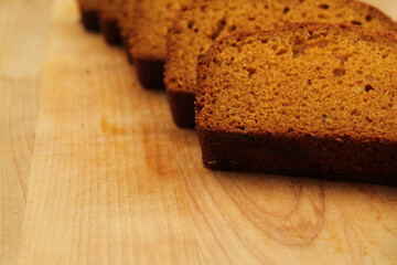 Fresh Homemade Pumpkin Bread Sliced on Wooden Cutting Board