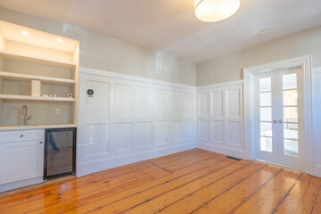 Elegant Interior Room with Built-In Bar and French Doors And Wainscoting