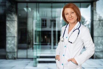 A joyful young female nurse outside a medical hospital