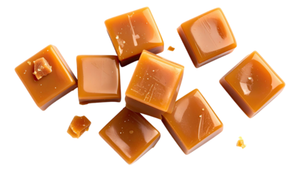 Glossy, caramel-colored cubes scatter on a dark, stark background