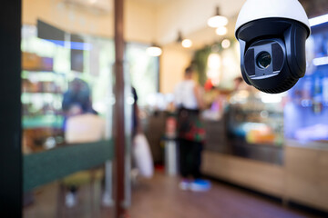 Security CCTV camera monitoring inside modern cafe for safety surveillance and business protection...
