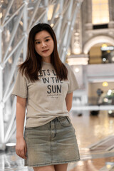 An elegant girl wearing a short skirt and T-shirt