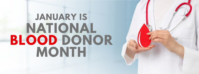 Medical professional holds a blood drop symbol in a clinic