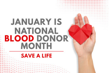 A hand holds a red origami heart symbolizing blood donation